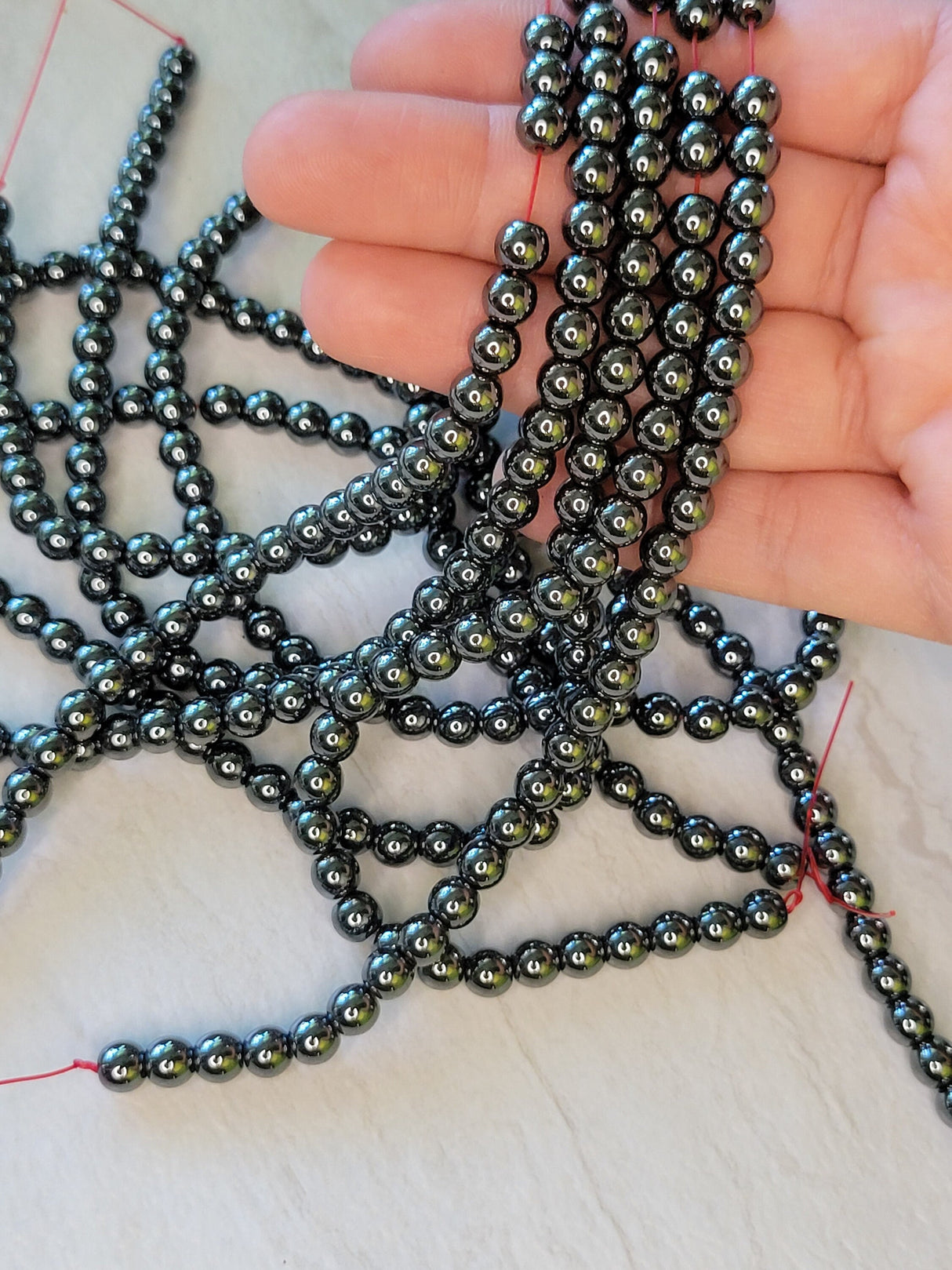 Non-magnetic synthetic hematite beads strands, aa round beads