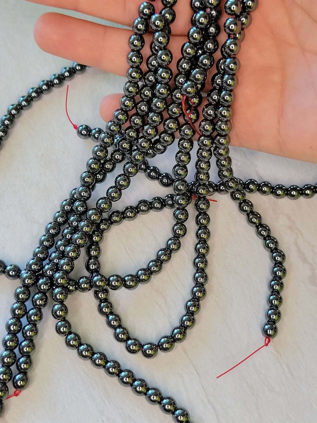 Non-magnetic synthetic hematite beads strands, aa round beads