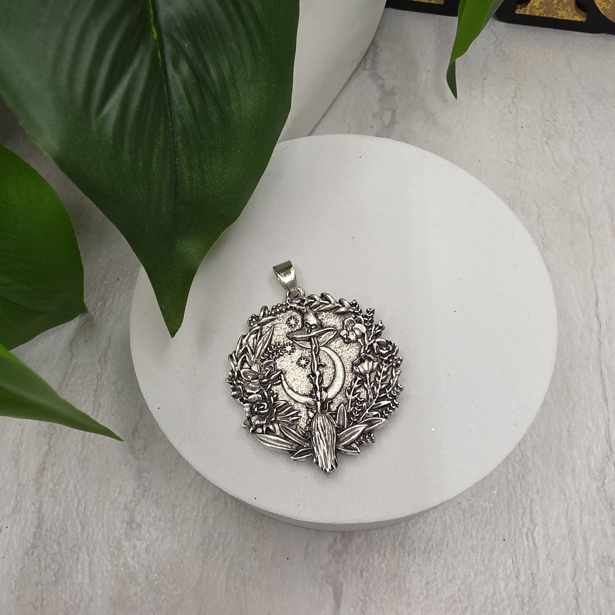 My Magic Place Shop silver witch broom and crescent moon pendant charm with intricate floral and star detailing.
