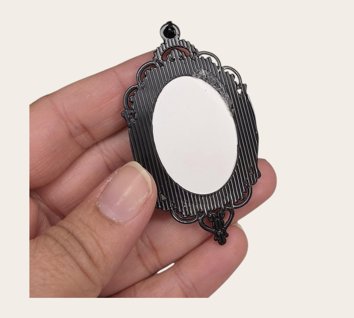 oval gothic bat pendant with a black ornate frame and white cabochon for DIY jewelry making.