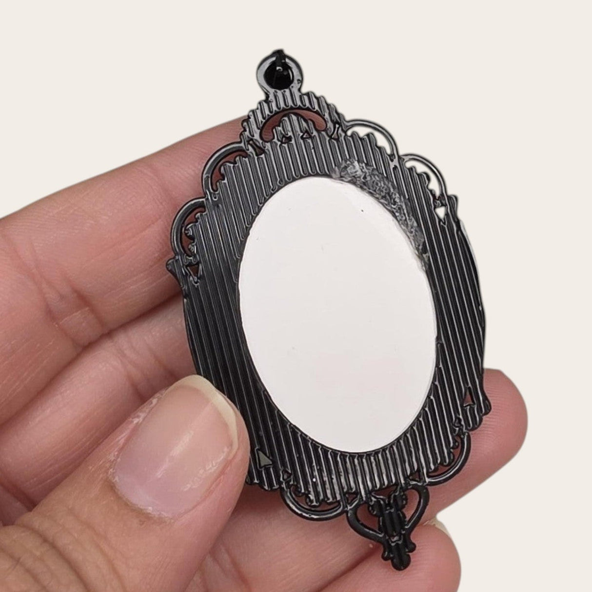oval gothic bat pendant with a black ornate frame and white cabochon for DIY jewelry making.