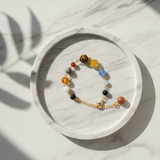 Bracelet with colorful beads on a marble tray