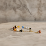 Bracelet with multicolored beads on a marble surface