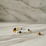 Bracelet with multicolored beads on a marble surface