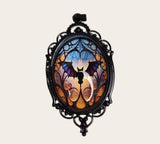 oval gothic bat pendant with a colorful glass cabochon in a black ornate frame