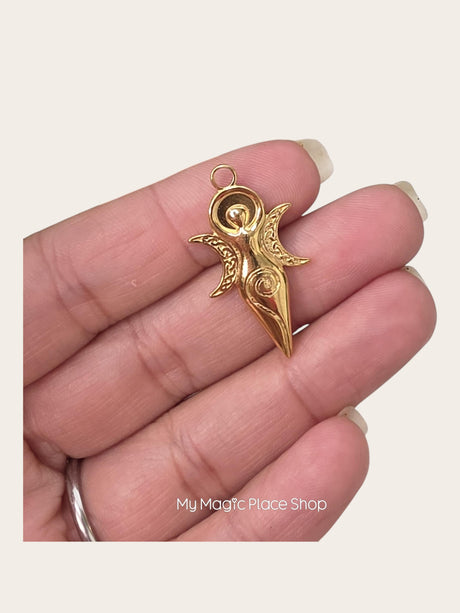 My Magic Place Shop gold goddess charm pendant with intricate spiral and moon detailing held in a hand
