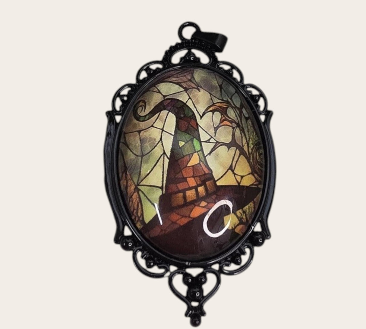 My Magic Place Shop witch hat cameo pendant with stained-glass art in an ornate black filigree gothic frame.
