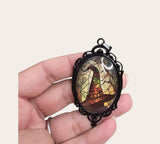 My Magic Place Shop witch hat cameo pendant necklace with stained-glass art in an ornate black filigree frame.