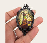 My Magic Place Shop witch hat cameo pendant with a stained-glass effect in an ornate black vintage filigree frame.