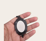 My Magic Place Shop witch hat cameo pendant necklace featuring an ornate vintage-style black filigree metal frame