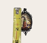My Magic Place Shop witch hat cameo pendant with stained-glass art in an ornate black filigree frame measured by tape.
